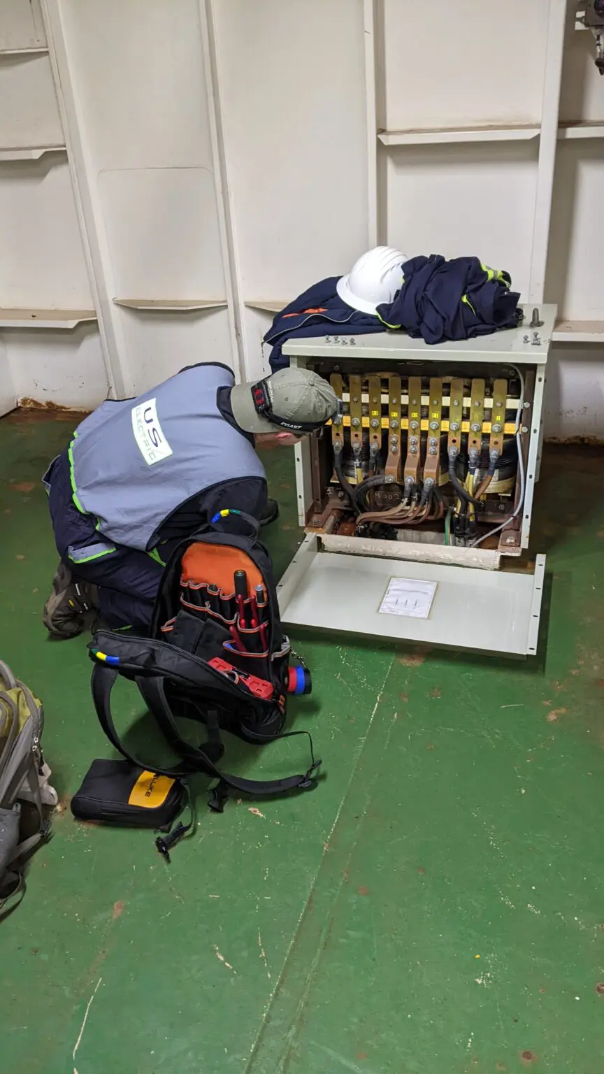 A man working on an electrical panel.