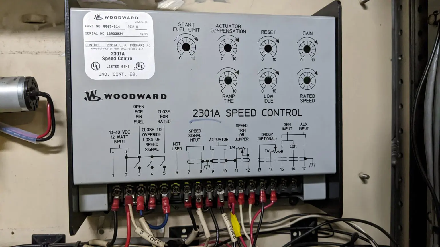 A control panel with many wires attached to it.