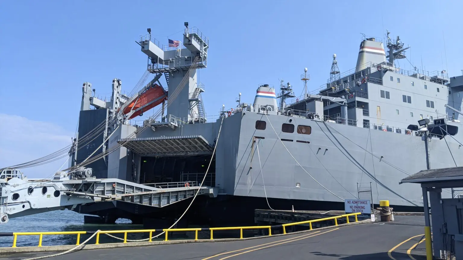 A large boat docked on the dock of an ocean.