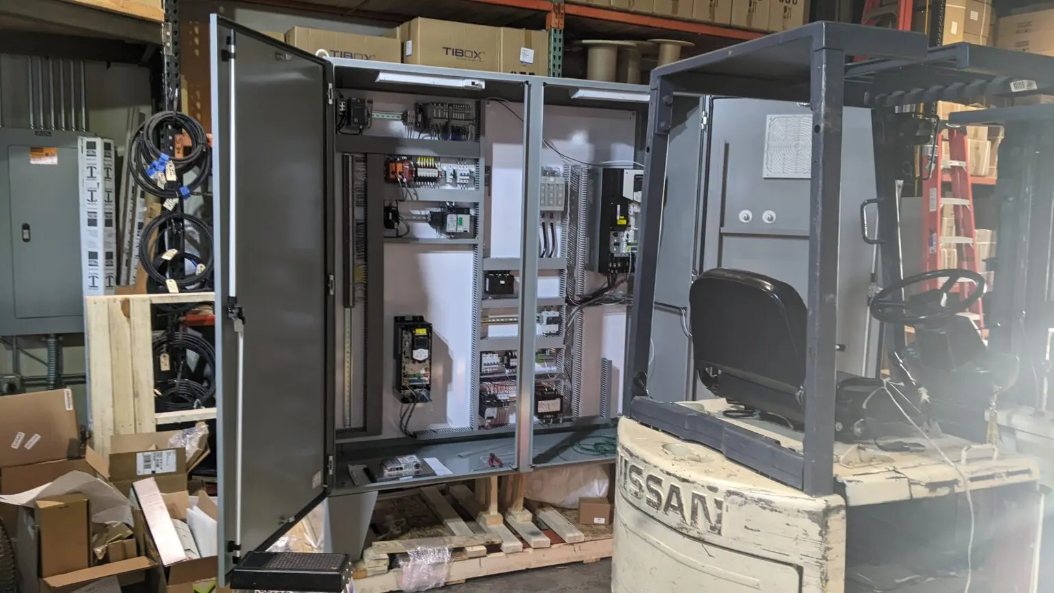 A large metal cabinet sitting on top of a wooden table.