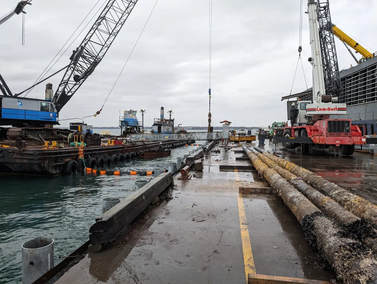 A dock with many large cranes in the water.