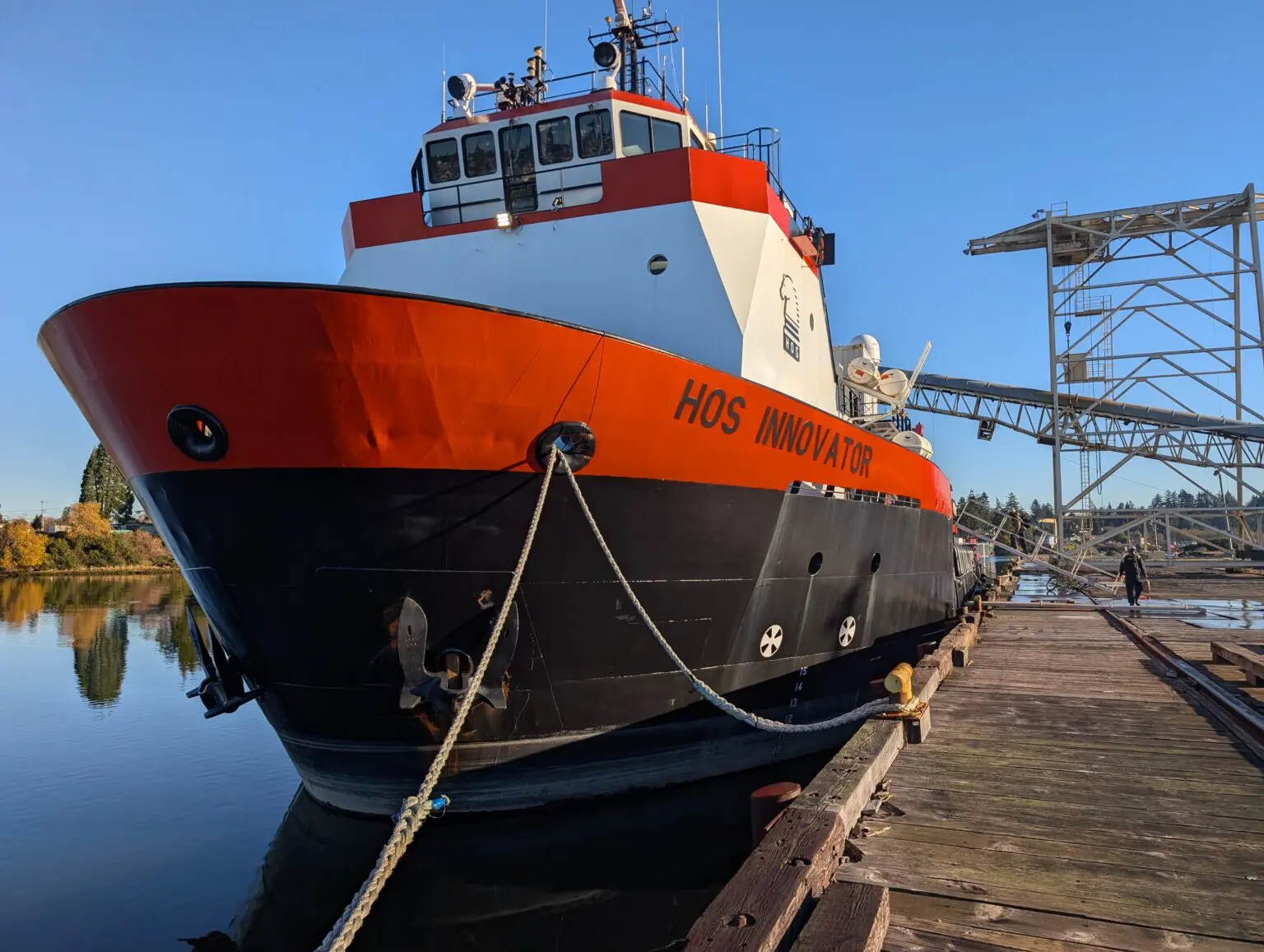A large boat is docked at the dock.